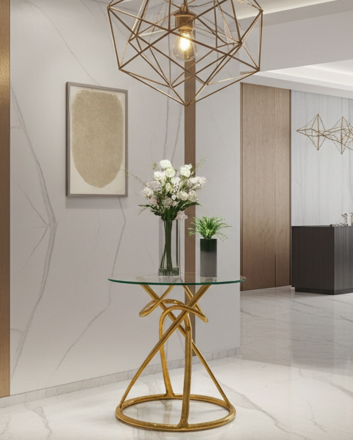 Modern interior with a luxury handmade brass entry table with glass top, gold geometric chandelier, and white flowers.