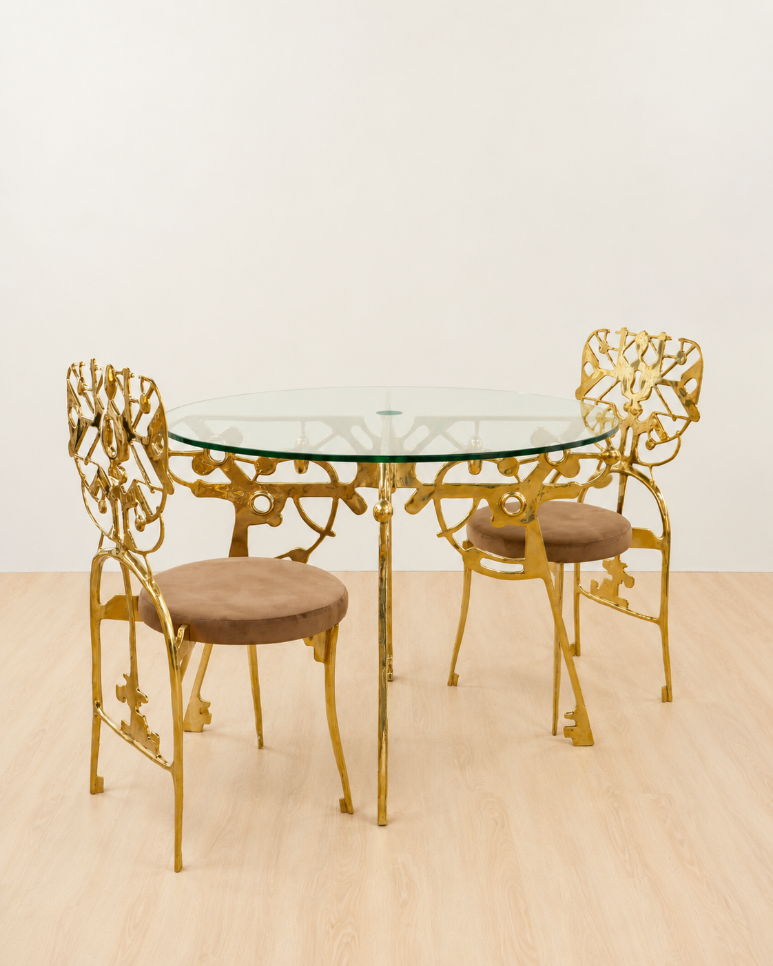 Gold brass dining set with a glass table top on gold brass base.