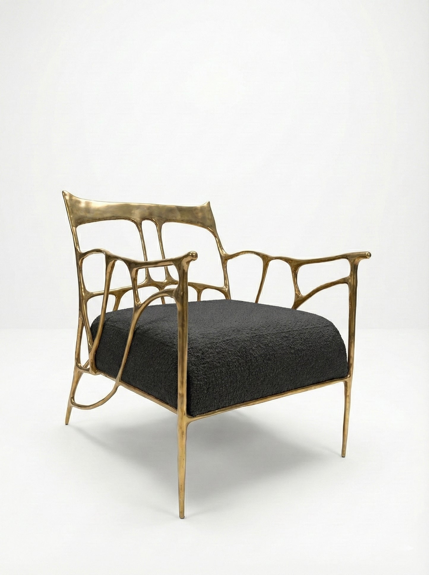 modern brass chair with gold frame and black cushion