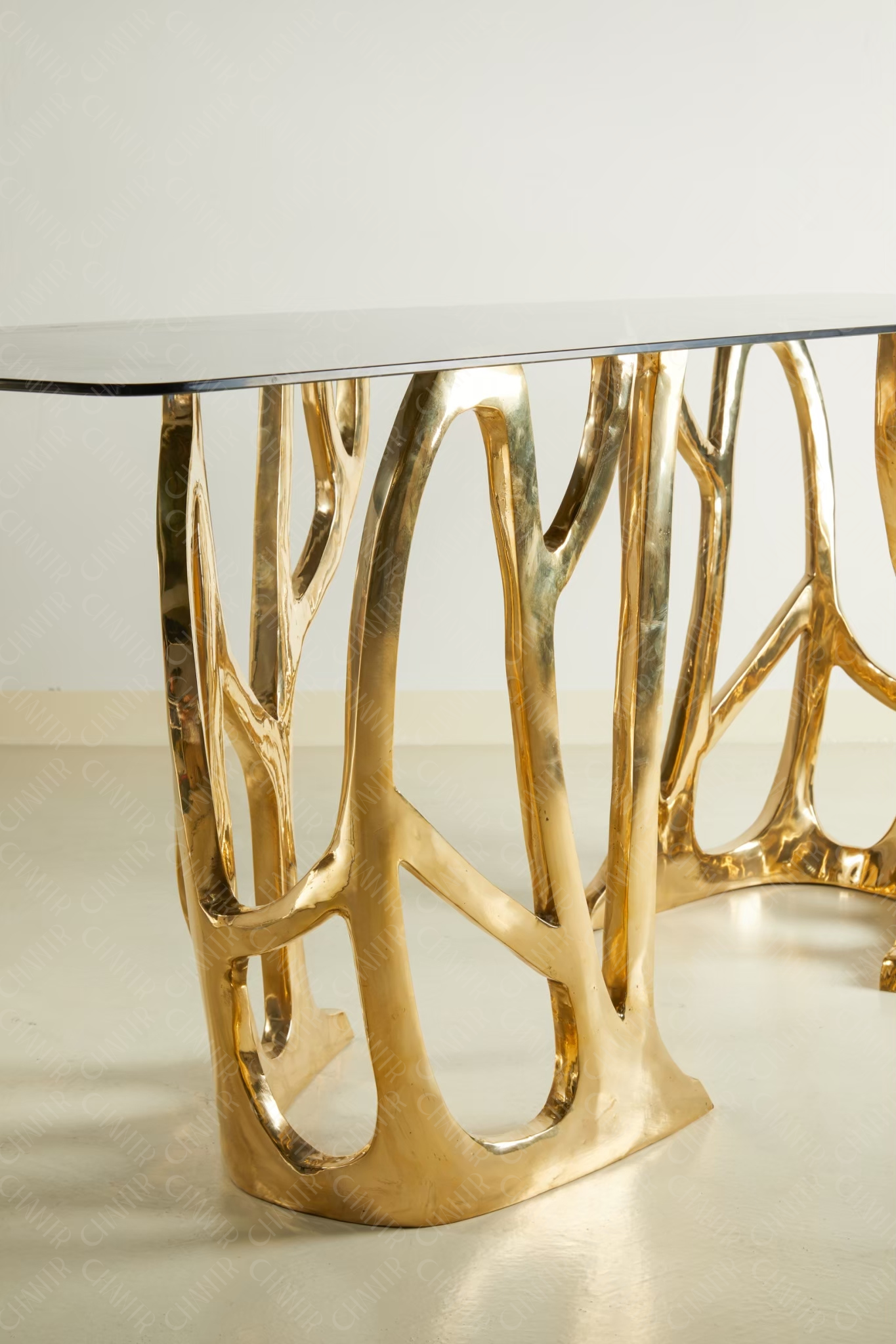 Zoomed in - Gold brass luxury handmade furniture console table with glass top, perfect for modern luxury decor, on a white background