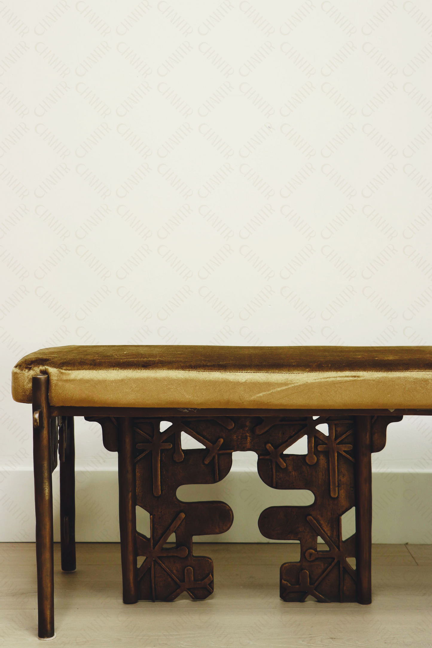 half of Brass luxury handmade furniture bench with cushioned seat, ideal for modern luxury decor, against a white wall.