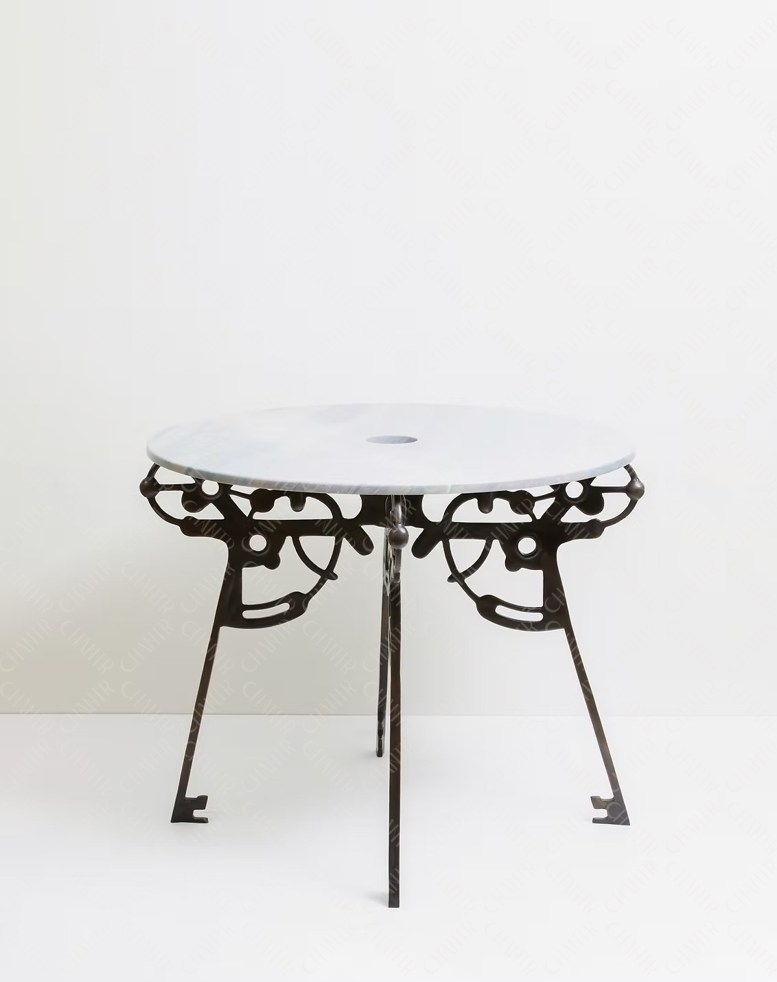 Round luxury handmade furniture table with white marble top and decorative black brass legs, ideal for modern luxury decor, on a white background.