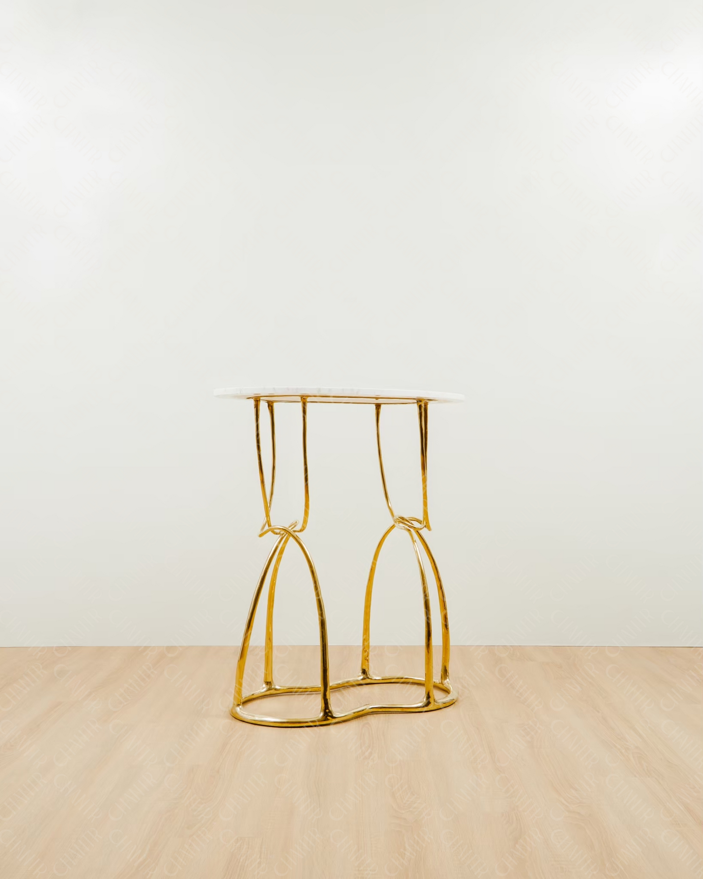 Side Angle - Gold brass luxury handmade furniture console, perfect for modern luxury decor, on a wooden floor with white wall background.