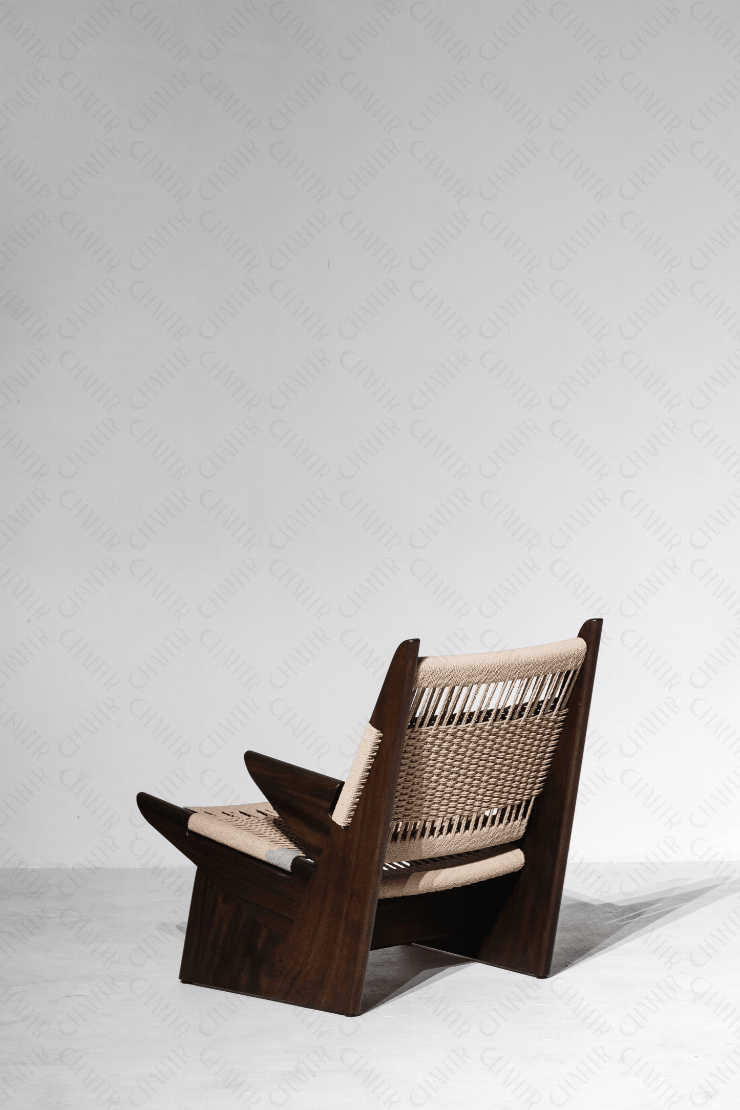 half back facing angle - Woven luxury handmade furniture chair with acacia wood frame, perfect for modern luxury decor, on a white background.