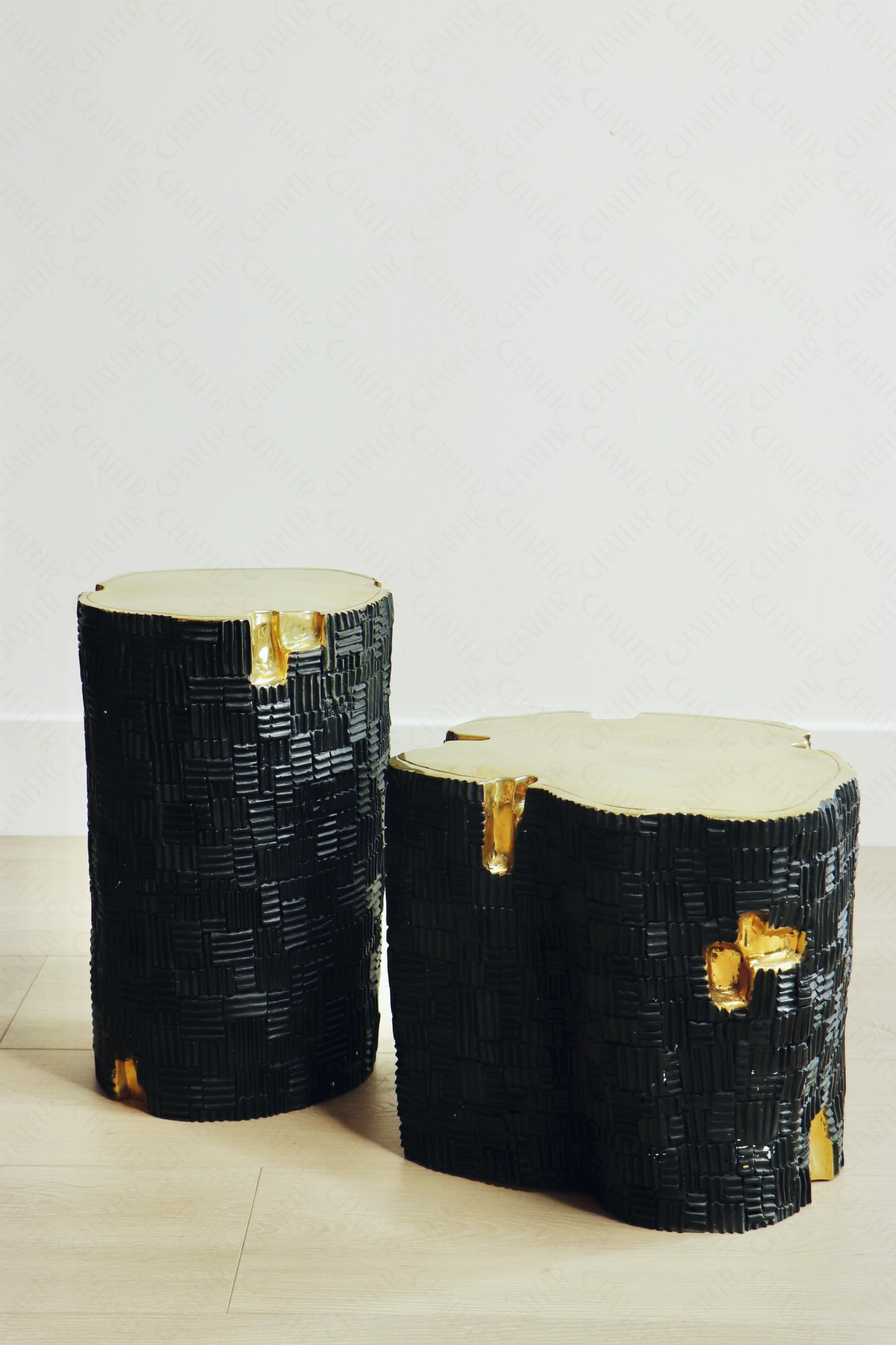 Two black decorative luxury handmade furniture stools, one tall and one short, with woven patterns, ideal for modern luxury decor, on a light background.