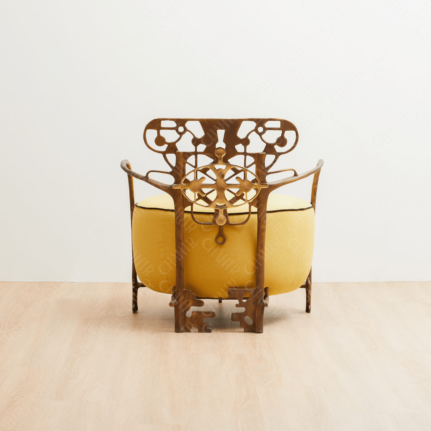 Decorative gold brass luxury handmade furniture chair with intricate metal frame, and yellow cushion ideal for modern luxury decor, on a white background. - back angle