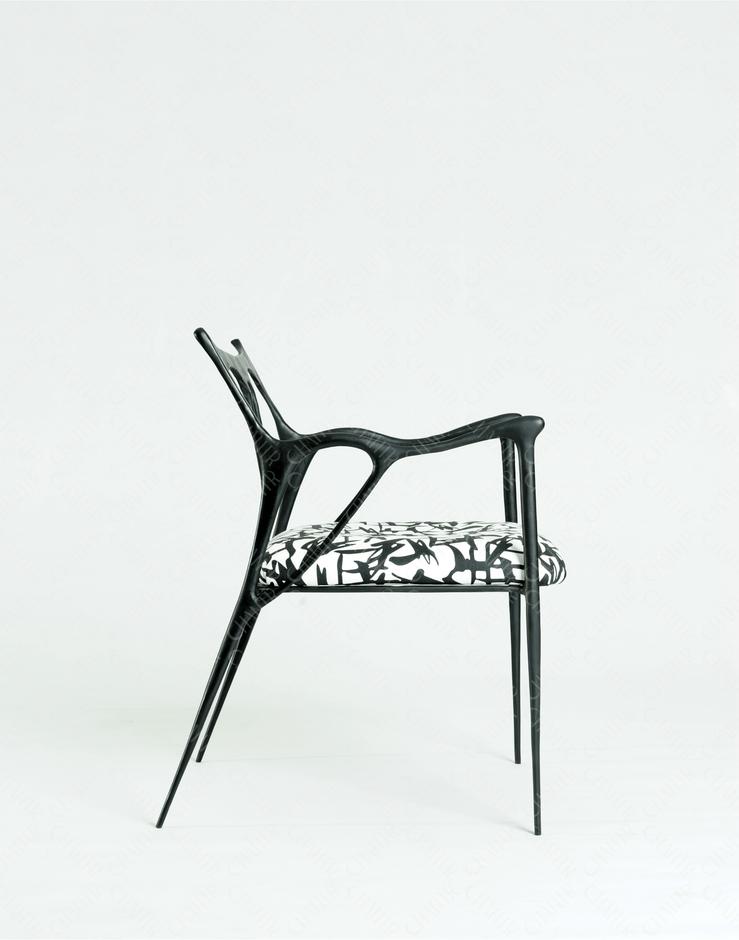 Black brass luxury handmade furniture chair with patterned cushion, ideal for modern luxury decor, on a wooden floor.