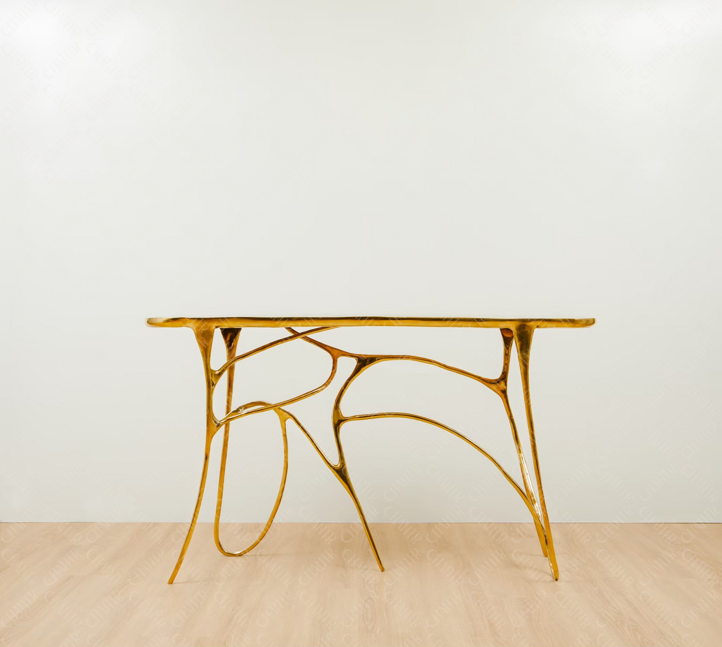 Gold brass luxury handmade furniture table with organic design, perfect for modern luxury decor, on a light wooden floor with white wall background.