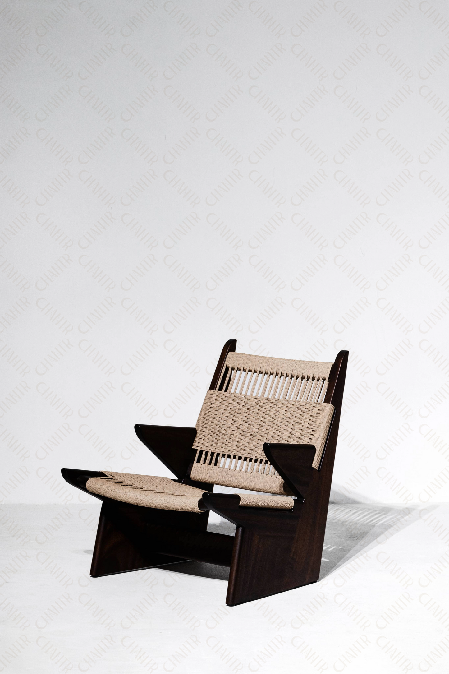 Left facing angle - Woven luxury handmade furniture chair with acacia wood frame, perfect for modern luxury decor, on a white background.