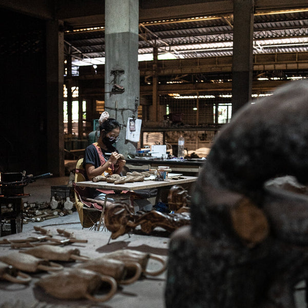 Women carving wax model for sculpture.