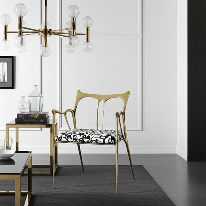 luxury handmade Gold chair with black and white patterned cushion in a modern room with a chandelier.