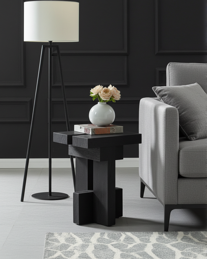 Modern living room with a luxury handmade black wooden side table, gray armchair, and floor lamp.