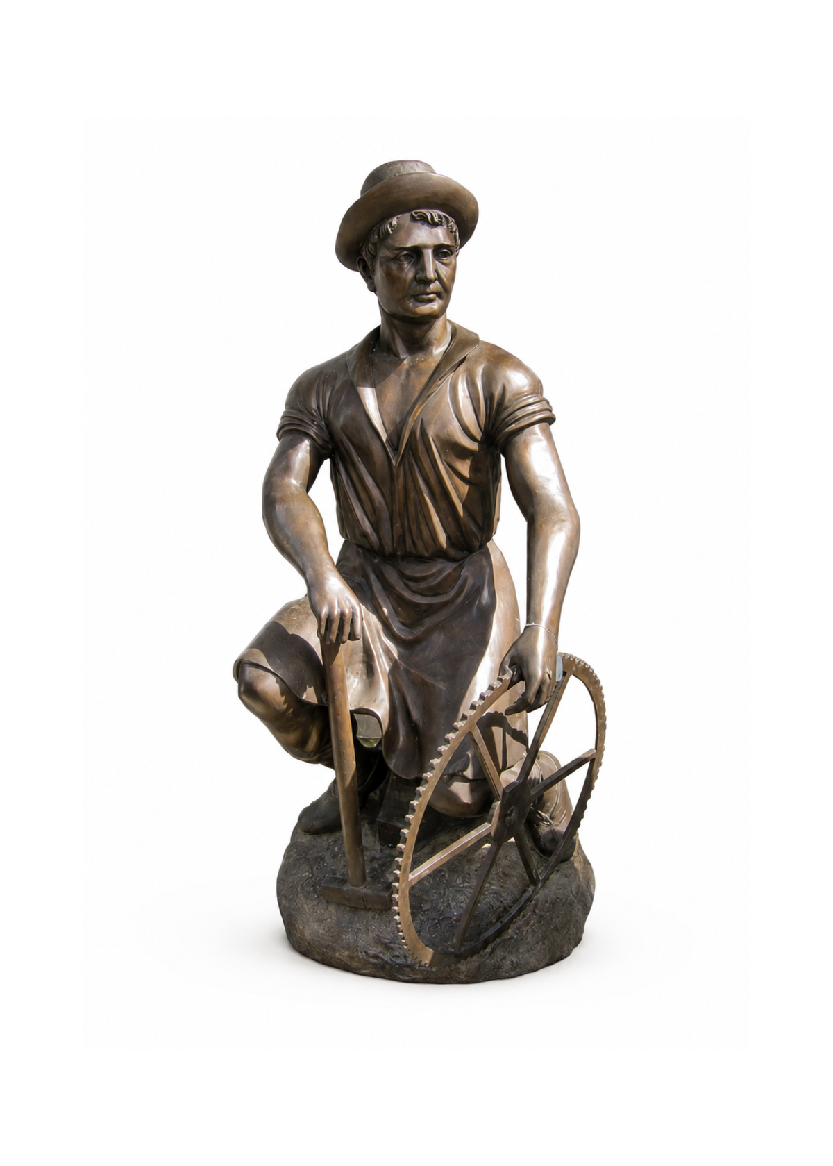 A bronze sculpture of a worker kneeling beside a large gear wheel, holding a tool in one hand, photographed on a plain white background.