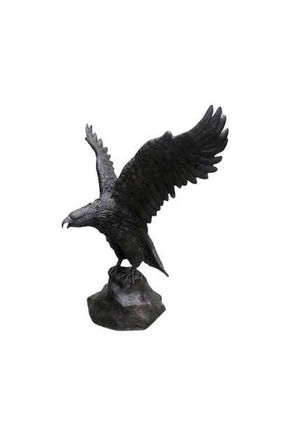 Bronze statue of an eagle with outstretched wings on a white background
