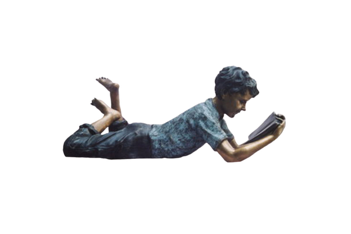 Statue of a person lying on their stomach reading a book against a white background