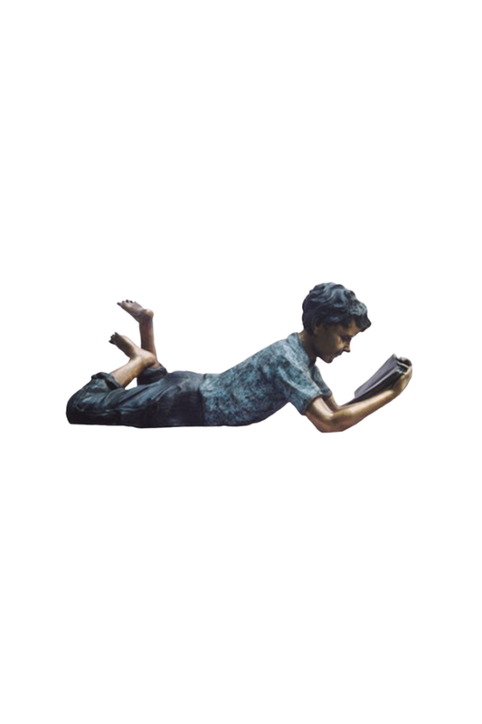 Bronze sculpture of a person lying on their stomach reading a book