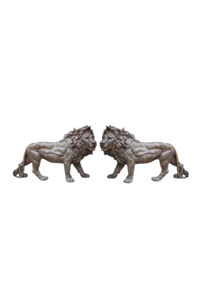 Two bronze lion statues on a white background