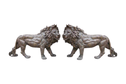 Two bronze lion statues on a white background