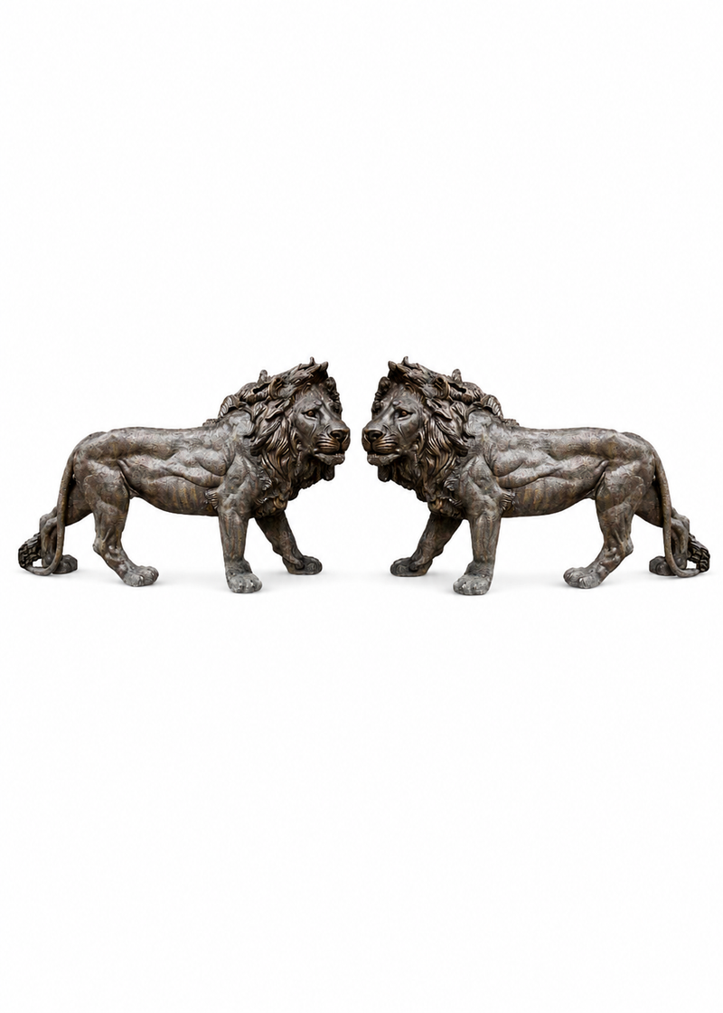 A pair of bronze lion statues facing each other, shown against a plain white background.