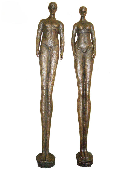 Two bronze luxury handmade furniture statues of standing figures, ideal for modern luxury decor, on a white background.