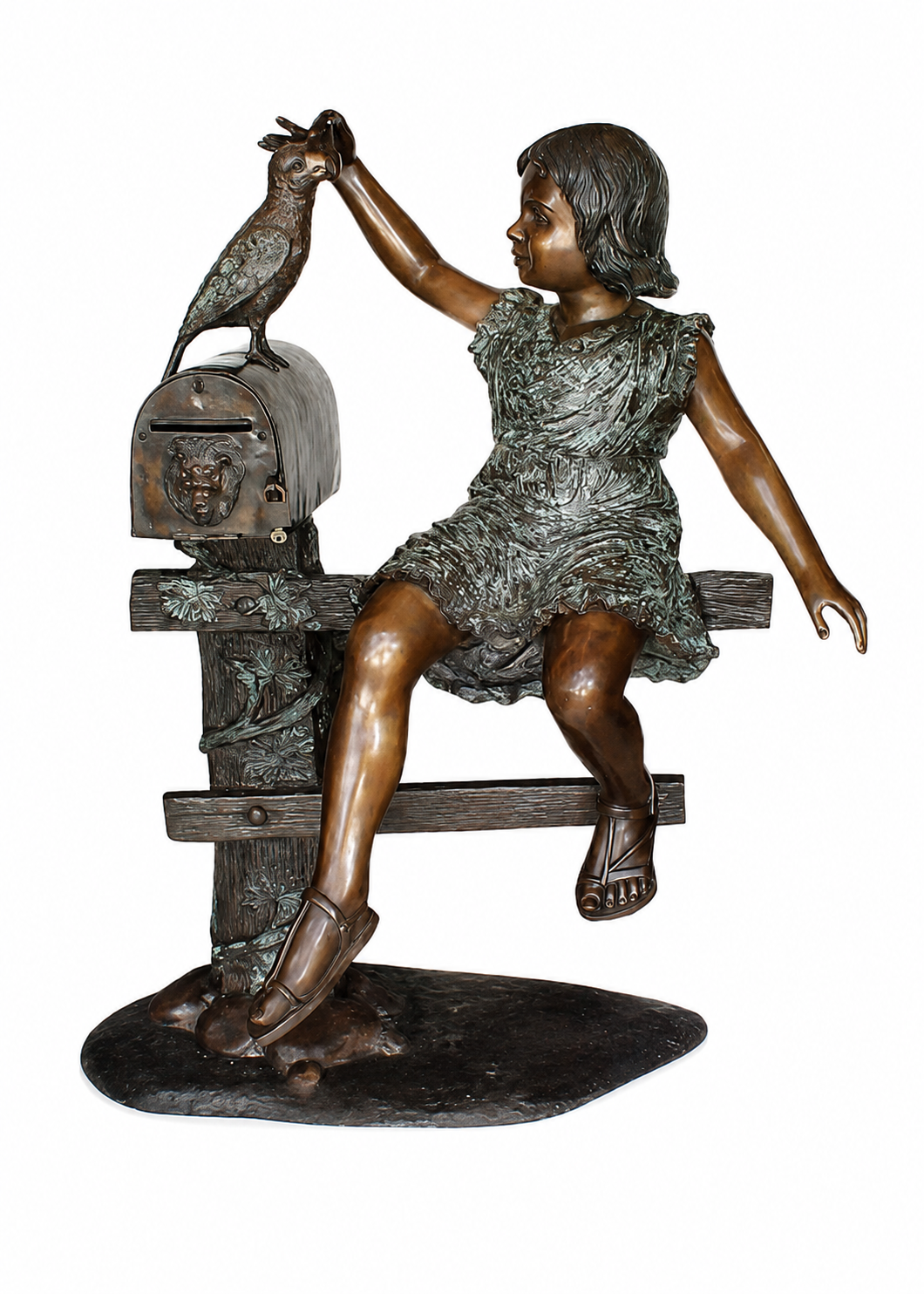 Bronze sculpture of a young girl sitting on a bench and reaching toward a bird perched on a mailbox, set against a plain white background.