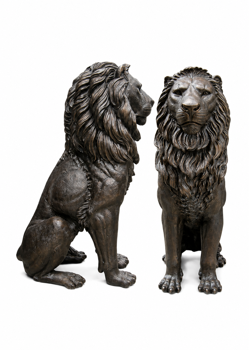 Two bronze lion statues, one seated and one standing, shown side by side on a plain white background.