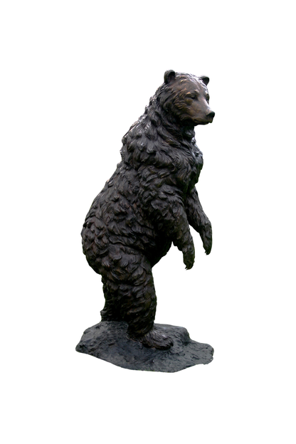 Bronze statue of a bear standing on its hind legs against a white background