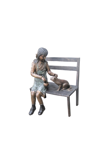 bronze Statue of a woman sitting on a bench with a dog on a white background