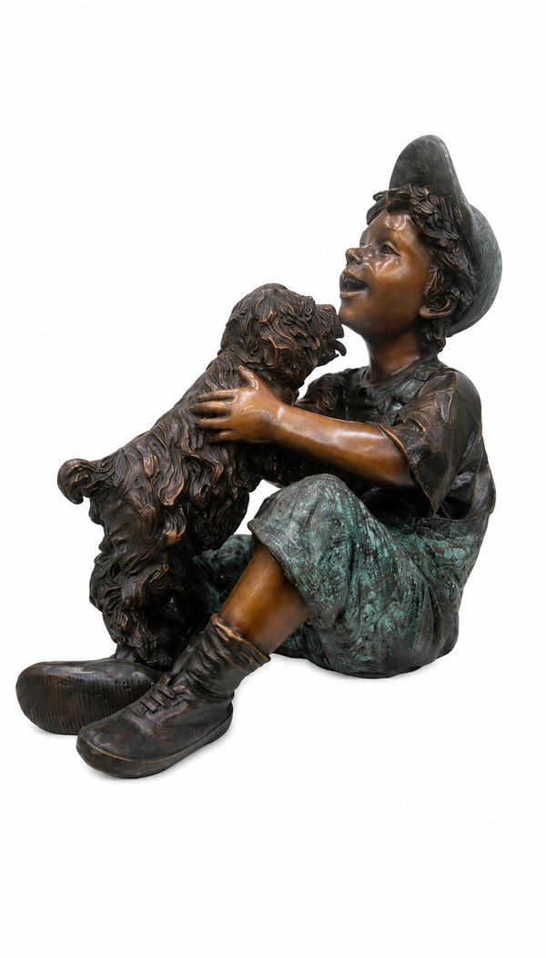 Bronze sculpture of a young boy in a hat and boots hugging a small dog, shown on a plain white background.