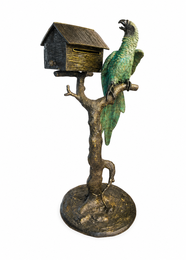 A decorative bronze sculpture featuring a small birdhouse mounted on a tree trunk base with a green parrot perched on a branch, isolated on a white background.