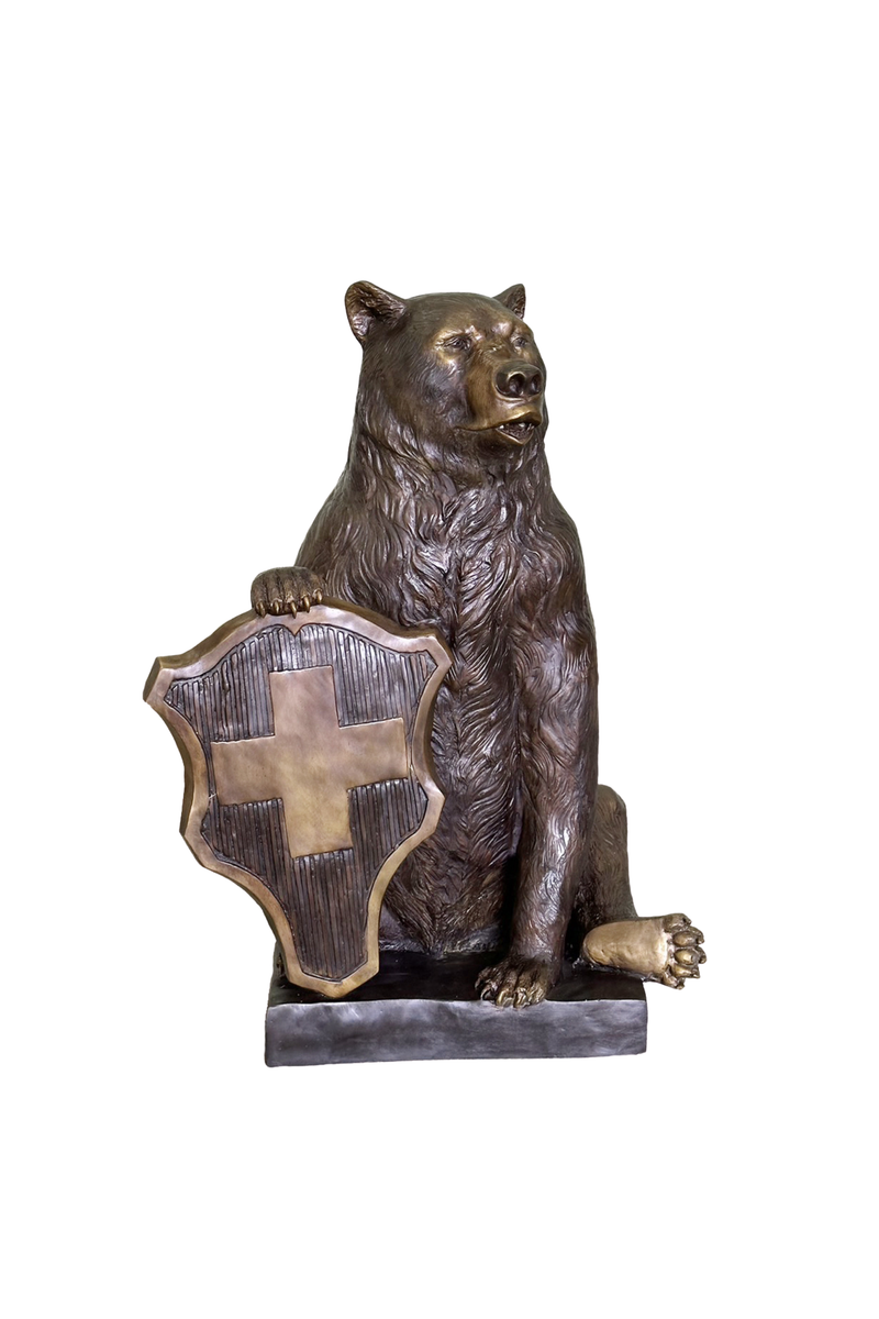 Bronze statue of a bear holding a shield with a cross on a white background