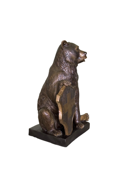 Bronze statue of a bear on a white background