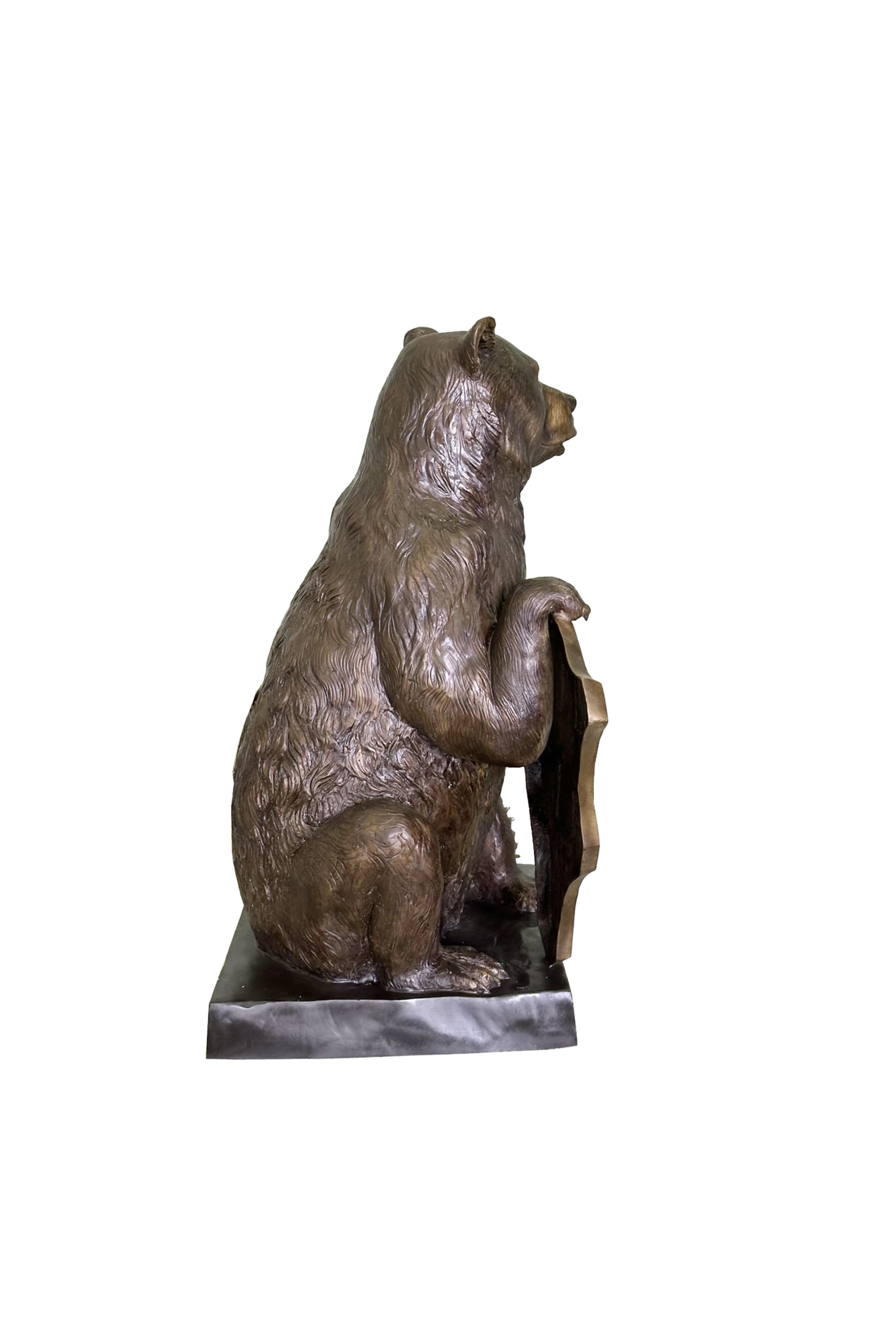 Bronze statue of a sitting bear on a white background