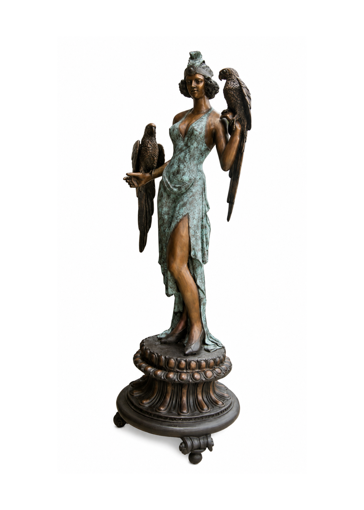A bronze sculpture of a classical female figure standing on a decorative pedestal base, with two birds perched on her shoulders and held in her hands. The figure has a weathered greenish-blue patina with darker bronze shading, set against a plain white background.