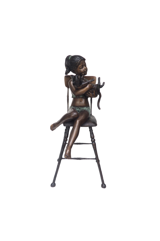 Bronze sculpture of a girl sitting on a stool with a white background