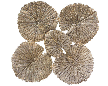 Four decorative stone coasters with leaf-like patterns on a white background