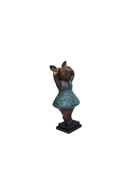 Statue of a piggy in a dress on a white background