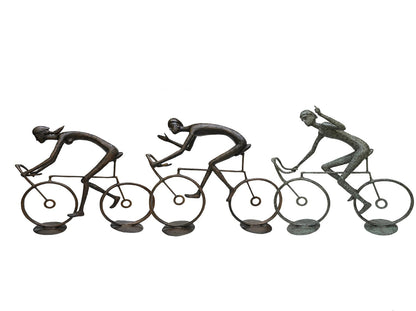 Bronze luxury handmade furniture sculpture of three cyclists, perfect for modern luxury decor, on a white background.