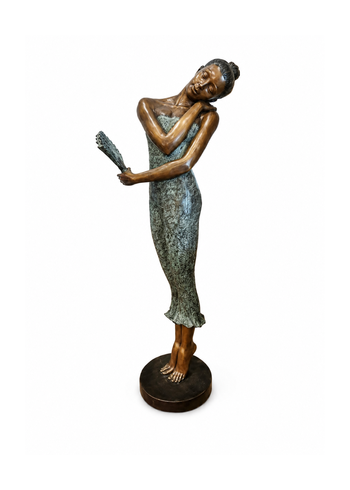 A bronze sculpture of a woman in a flowing dress holding a fan, standing on a round base against a plain white background.