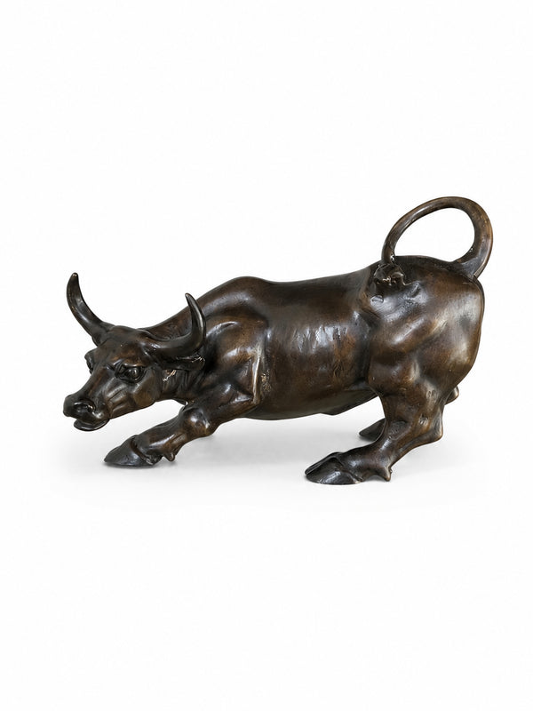 Bronze bull sculpture on a white background