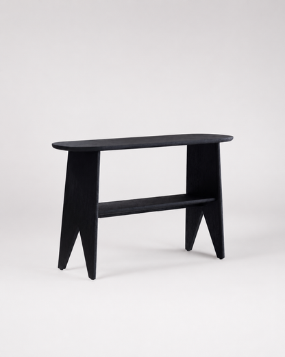 A minimalist black wooden console table with a rounded rectangular top, angled legs, and a lower shelf, photographed against a seamless light gray studio background.