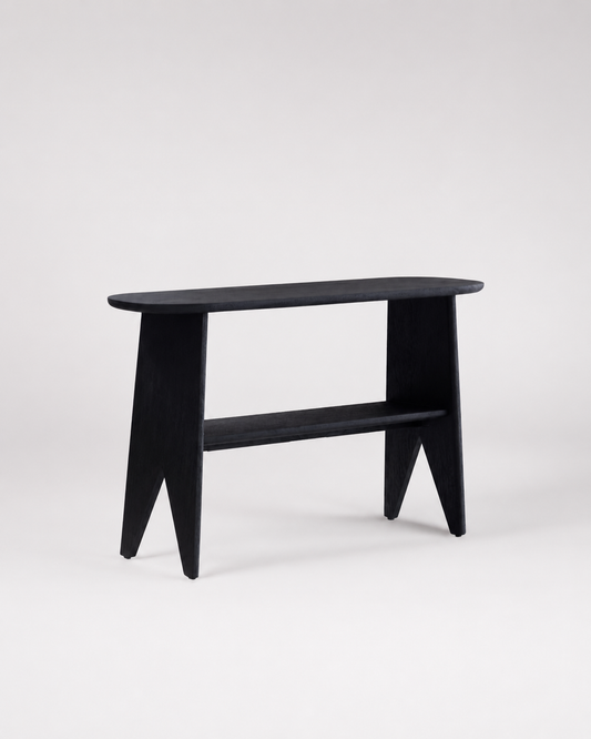 A minimalist black wooden console table with a rounded rectangular top, angled legs, and a lower shelf, photographed against a seamless light gray studio background.