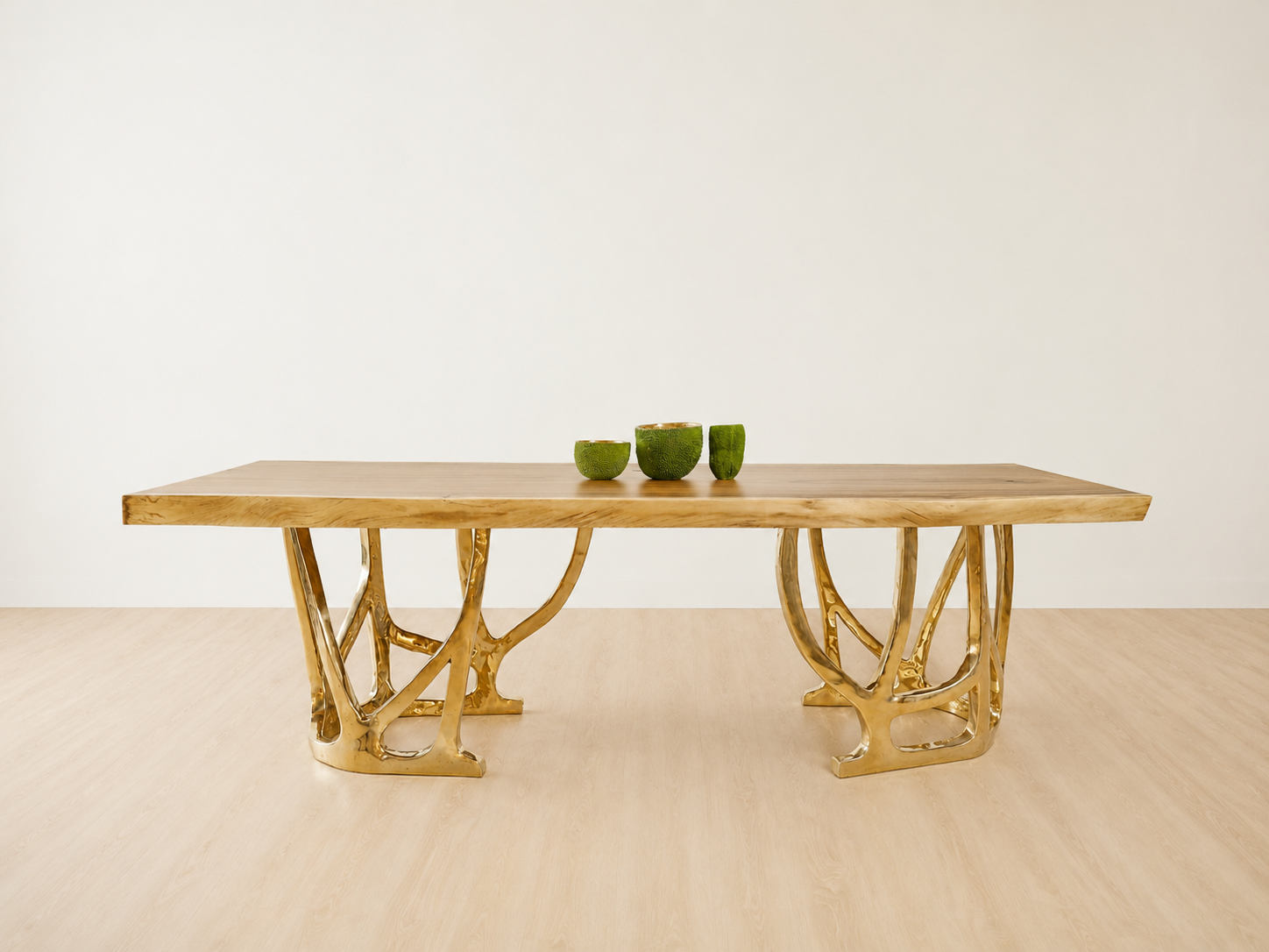 straight view of a dining table with gold bronze base and wood table top.