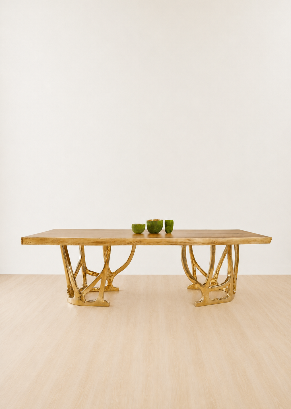 straight view of a dining table with gold bronze base and wood table top.