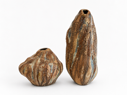 Two ceramic vases with textured, earthy brown glaze on a white background