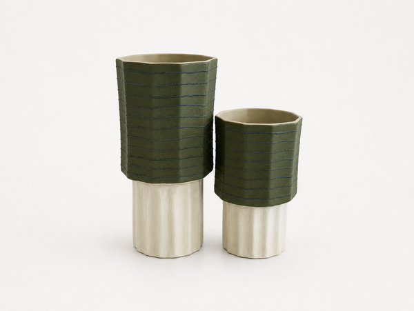 Two sized ceramic vases with green and silver design on a white background