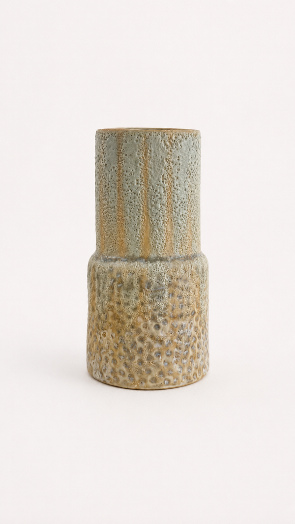 Blue, green and a mix of yellow textured ceramic vase on a white background