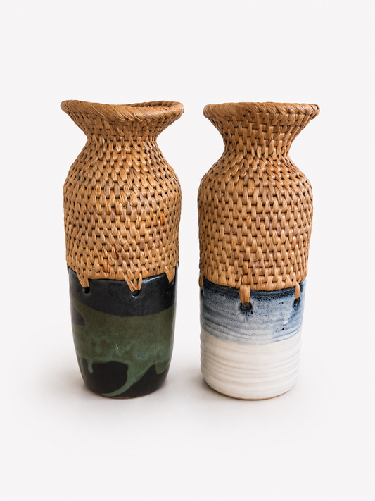 Two flared neck woven top and ceramic bottom vases on a white background