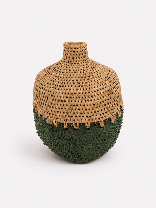 Vase with woven top and green textured brass bottom on a white background