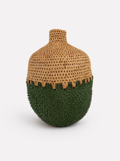 Vase with woven top and green textured brass bottom on a white background
